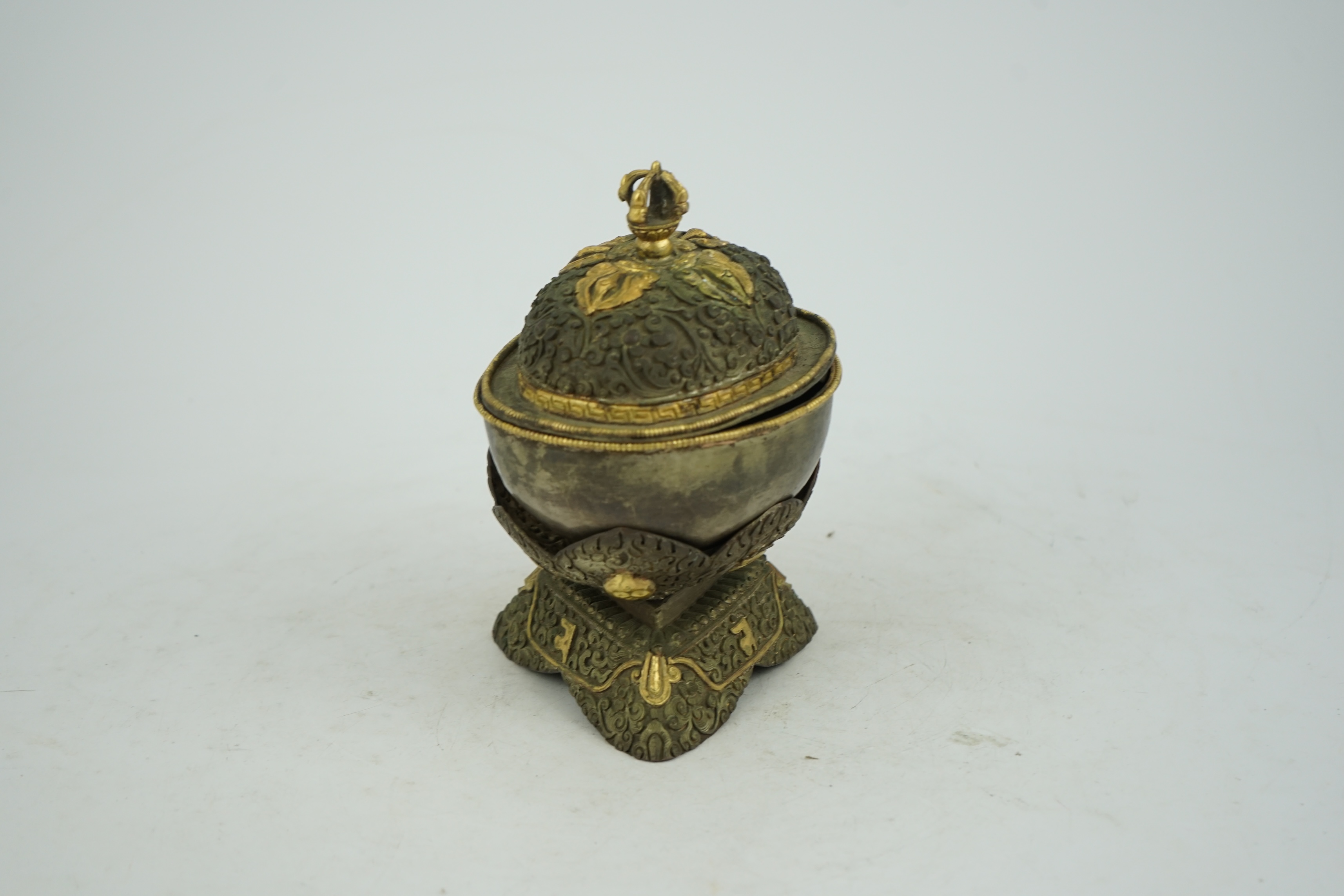 A Tibetan silvered and gilt repoussé copper and bronze capala bowl, late 19th/early 20th century